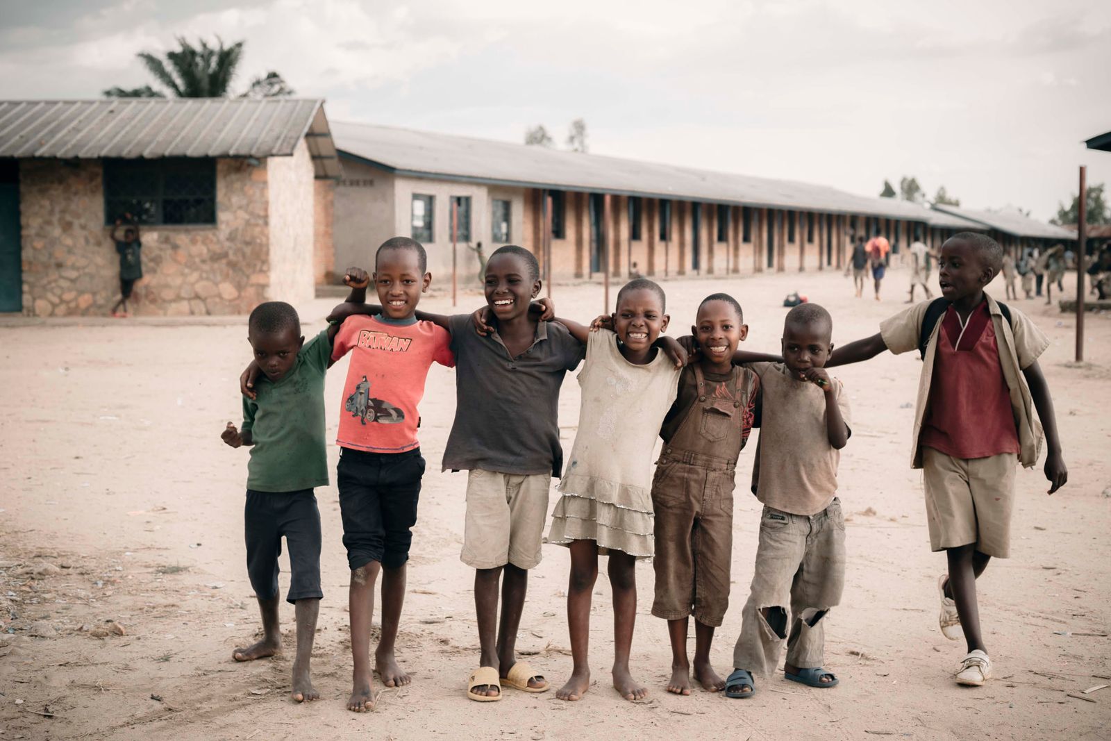 Group of happy children embracing each other in an African schoolyard setting