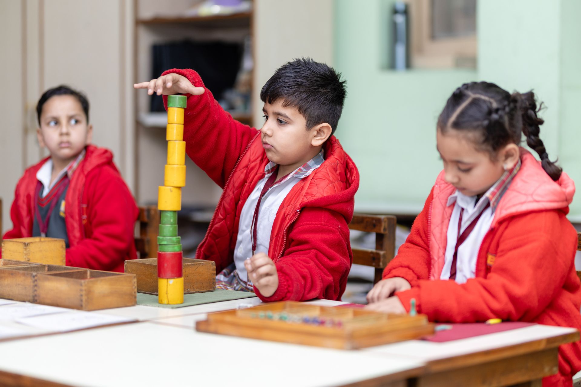 Children learning with Montessori materials in a classroom setting